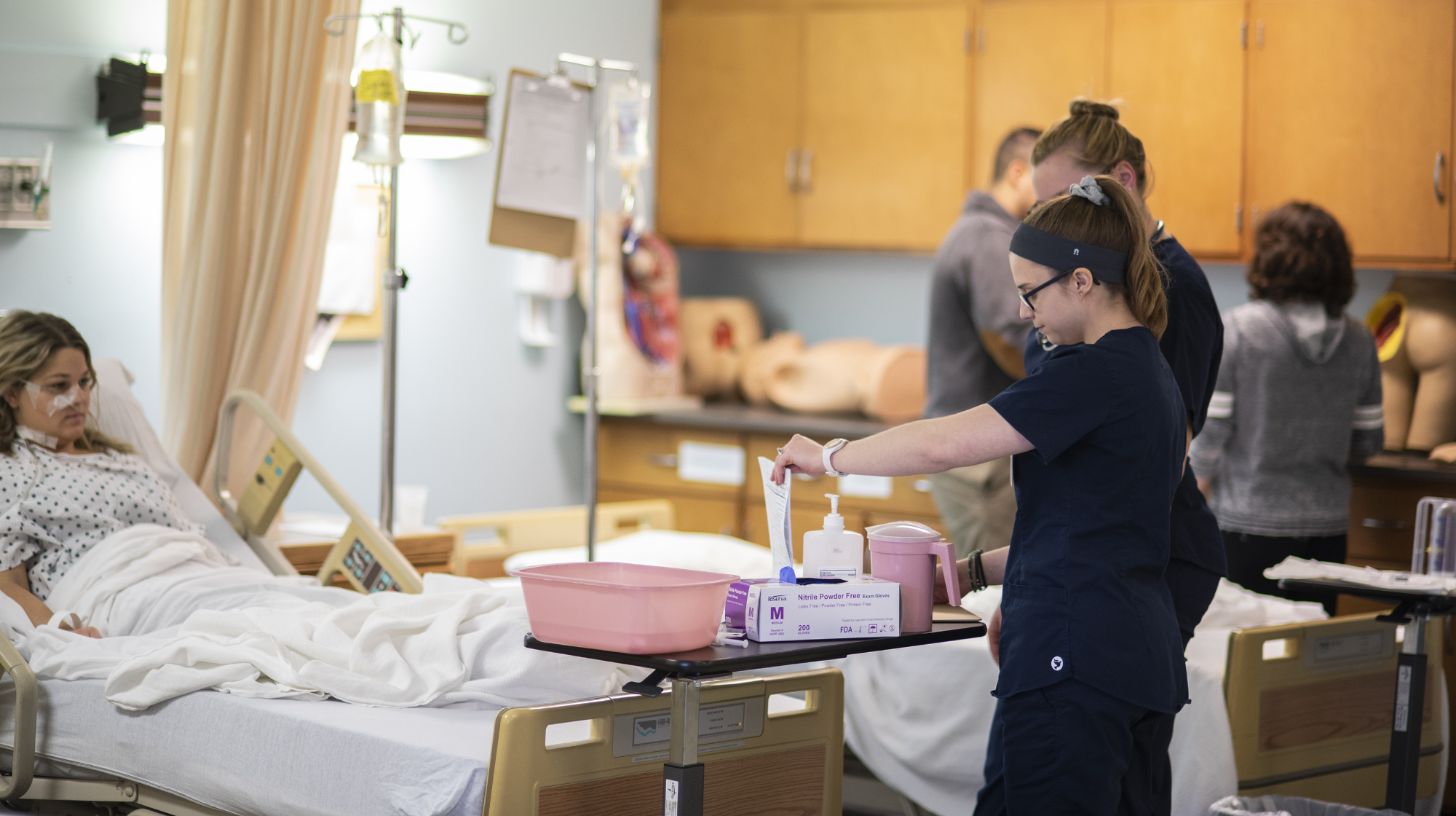 Nursing student reviewing chart of a patient.